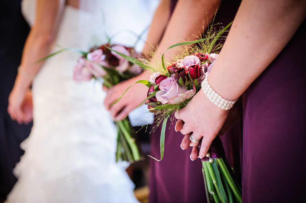 purple bridesmaids flowers and pearl bracelets