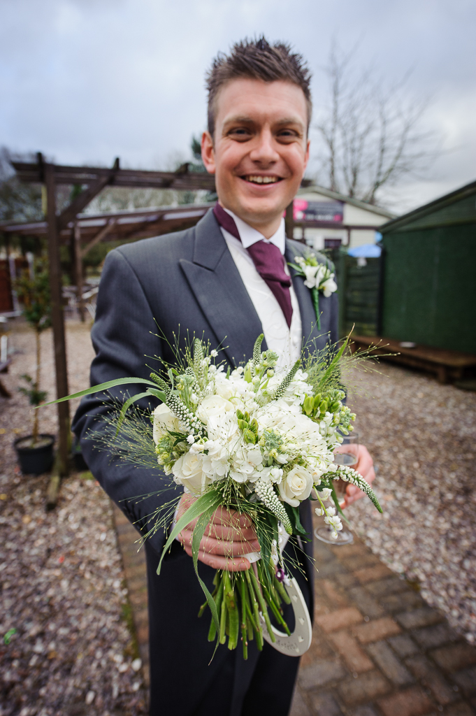 groom with wedding bouquet