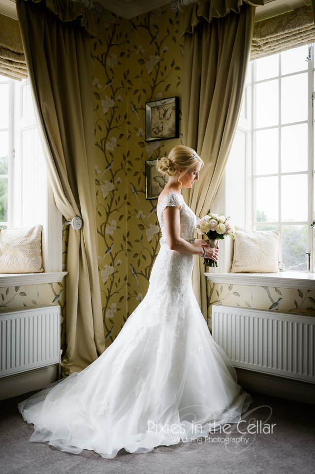 Bride in window Manchester wedding photographer