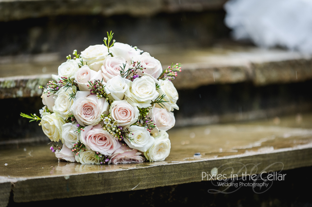 Pink and cream roses wedding bouquet with Rosemary