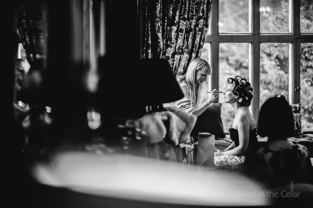 bride in rollers make-up being applied