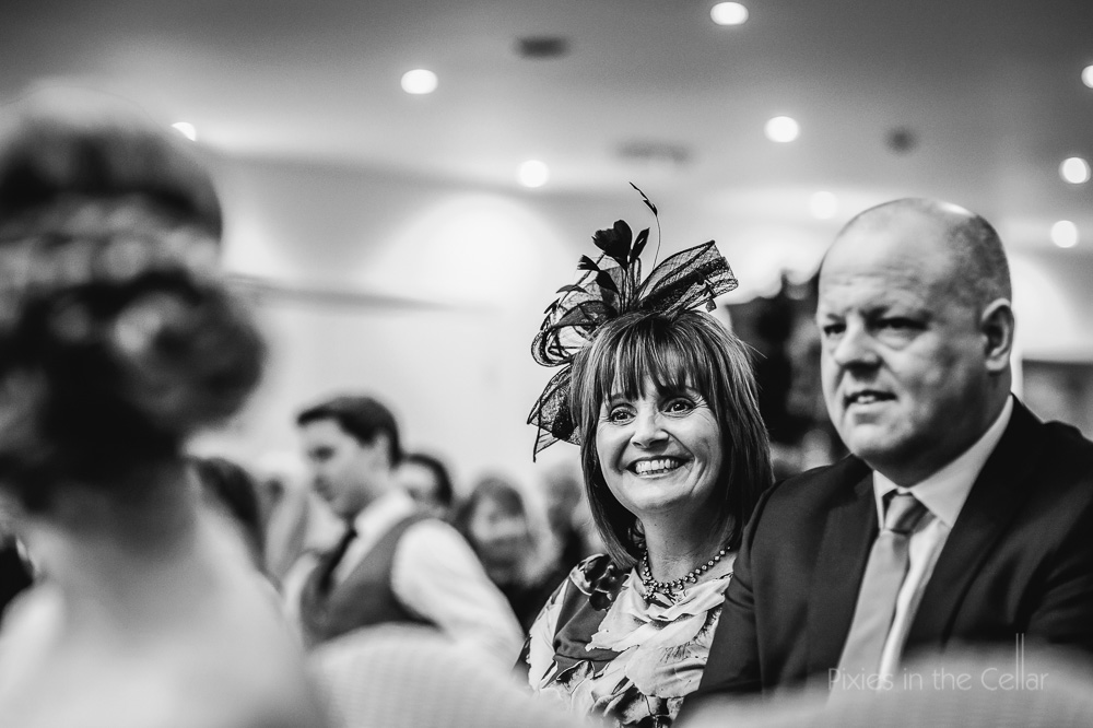smiley wedding guest with fascinator