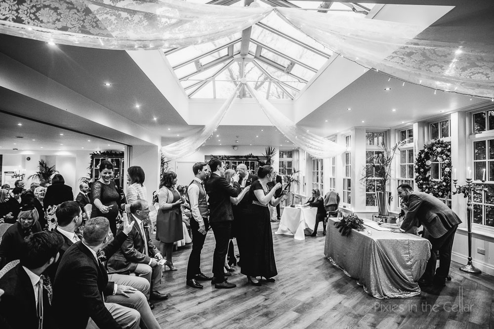 guests photographing bride and groom