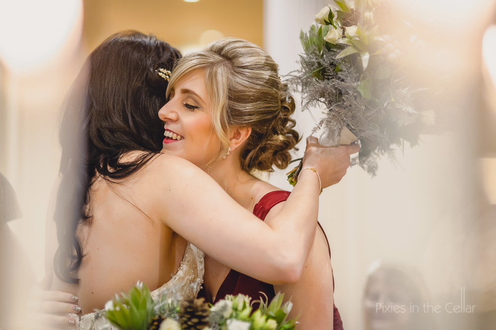 bride bridesmaid hug