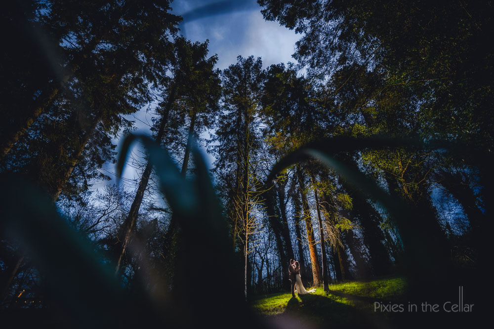 bride and groom in winter woods mitton hall