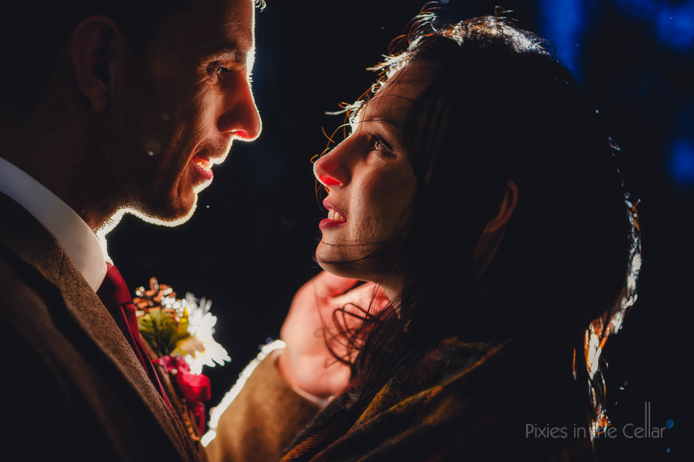 winter wedding close up lit bride groom looking at each other