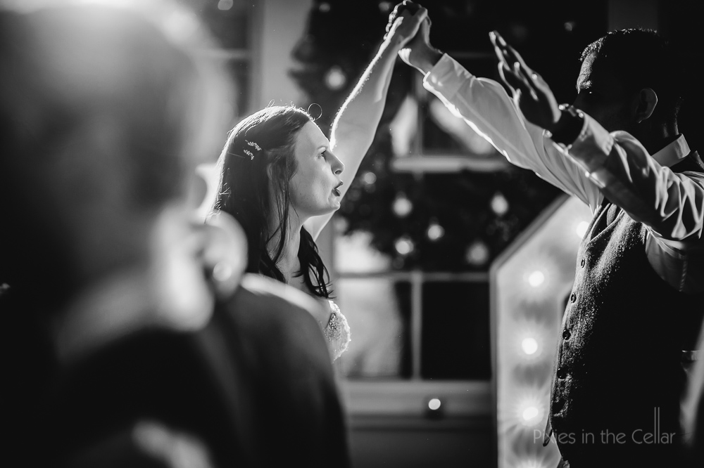bride groom dancing arms in air