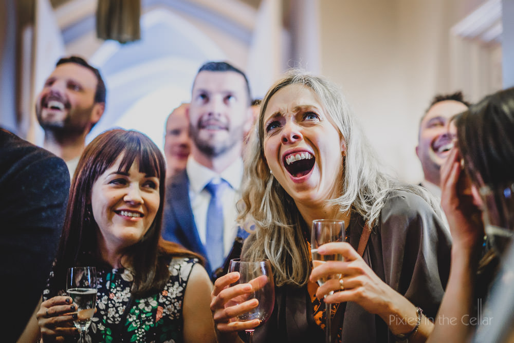 laughing wedding guests