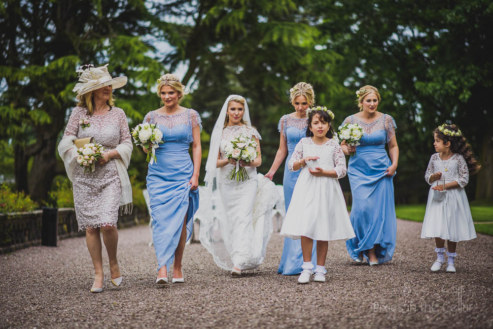 bride and bridesmaids walking to chapel at Capesthorne Hall