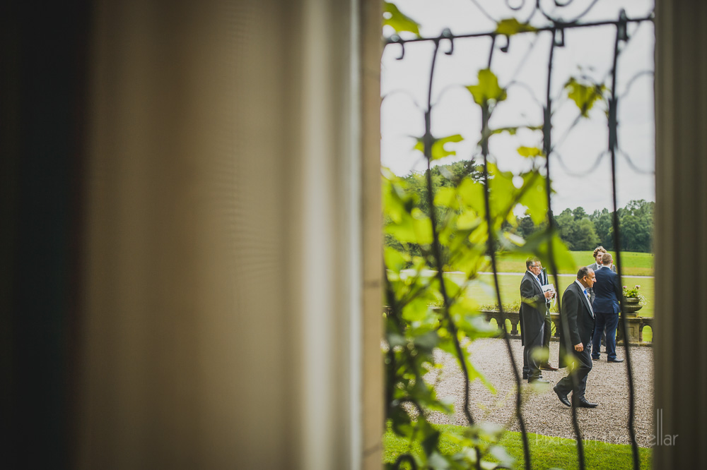 wedding guests through window Cheshire stately home